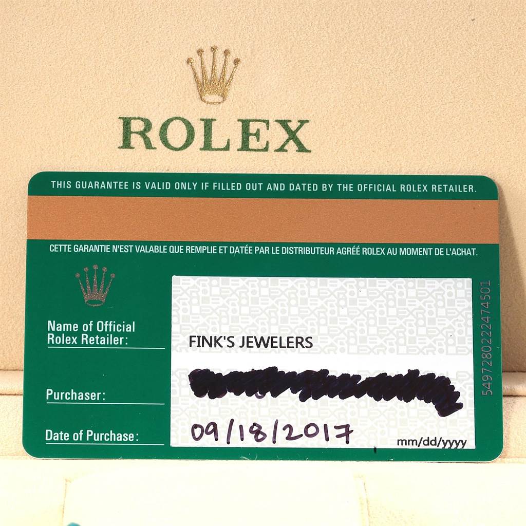 The image shows a guarantee card from Rolex for the Submariner model, detailing purchase information from Fink's Jewelers.