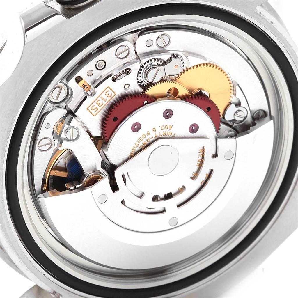 This is a close-up view of the movement inside a Rolex Submariner 16610LV Men's Stainless Steel Green Dial 16610LV Men's Stainless Steel Green Dial watch, showing its intricate internal gears and mechanisms.