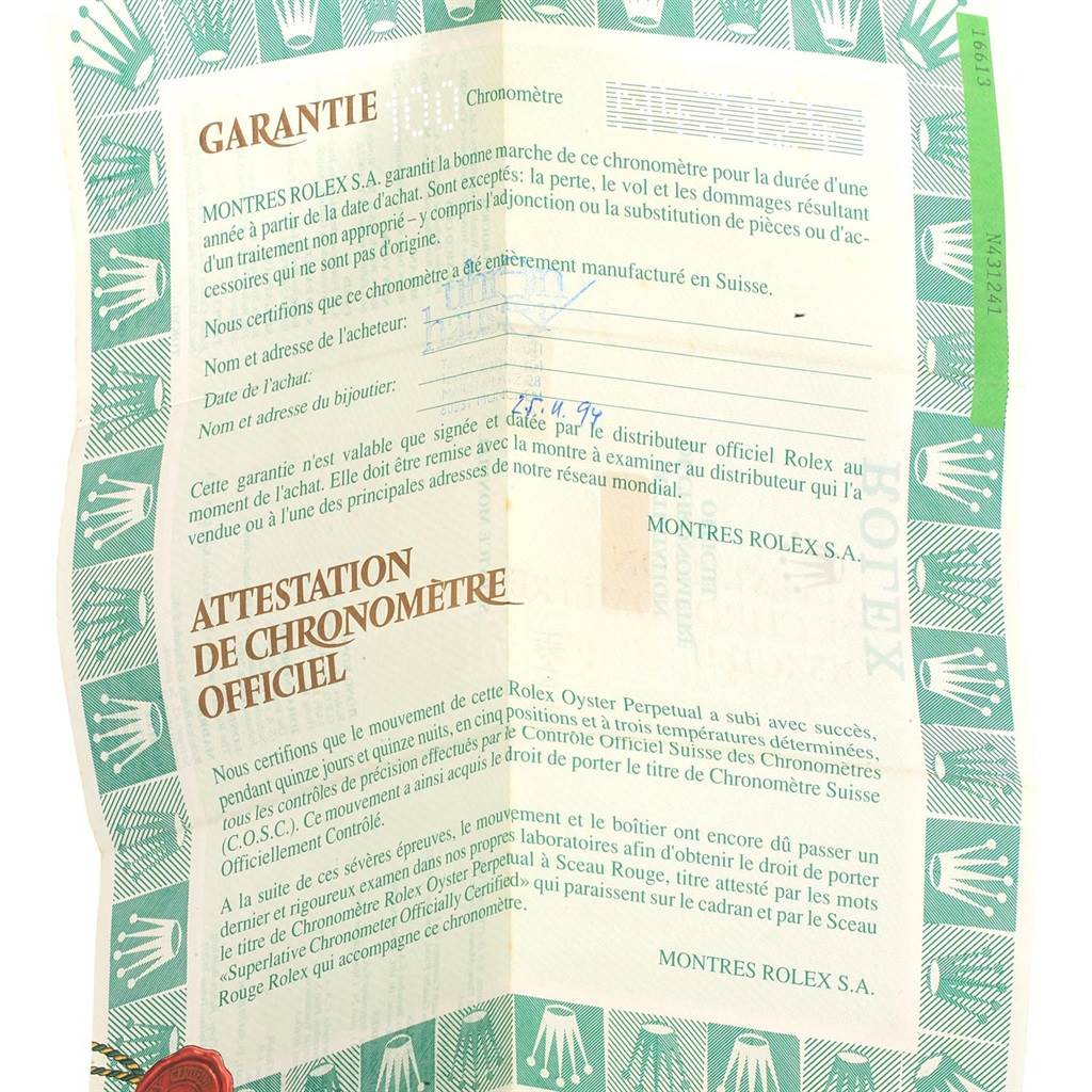 This image shows a close-up of the warranty certificate for the Rolex Submariner 16613 Men's Steel and Gold (two tone) Black Dial 16613 Men's Steel and Gold (two tone) Black Dial watch.