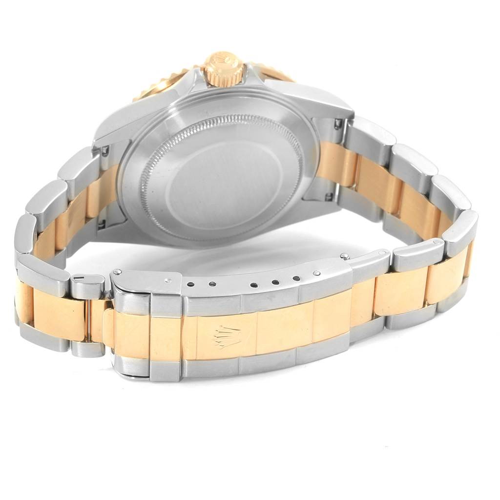 The image shows the back case, crown, and bracelet of a Rolex Submariner 16613 Men's Steel and Gold (two tone) Black Dial 16613 Men's Steel and Gold (two tone) Black Dial watch, highlighting its two-tone design.