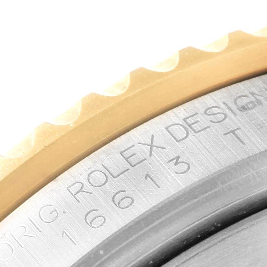 Close-up of the bezel and case edge of a Rolex Submariner 16613 Men's Steel and Gold (two tone) Blue Dial 16613 Men's Steel and Gold (two tone) Blue Dial, showing model details etched into the metal.