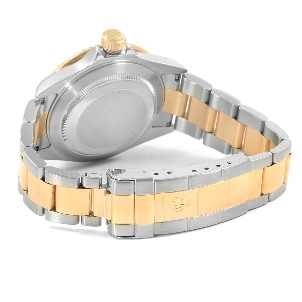 The image shows the back case, crown, and two-tone bracelet of a Rolex Submariner 16613 Men's Steel and Gold (two tone) Blue Dial 16613 Men's Steel and Gold (two tone) Blue Dial watch.