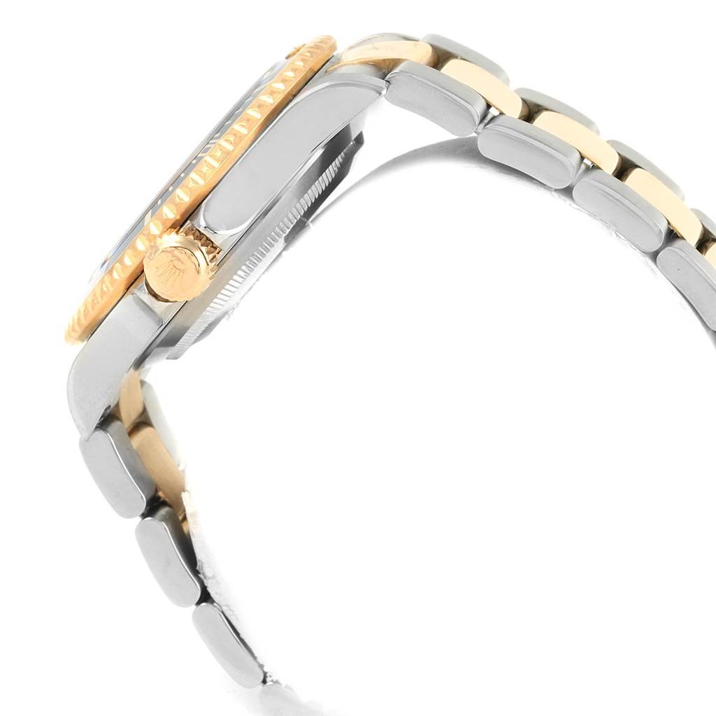 This image shows a profile view of a Rolex Submariner 16613 Men's Steel and Gold (two tone) Blue Dial 16613 Men's Steel and Gold (two tone) Blue Dial, highlighting its crown, bezel, and part of the bracelet.