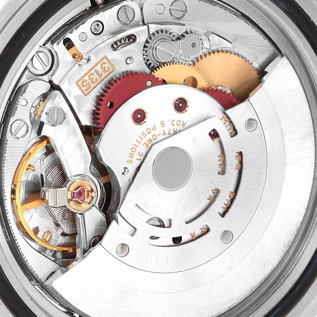 This angle shows a close-up view of the movement inside a Rolex Submariner 16613 Men
s Steel and Gold (two tone) Blue Dial 16613 Men
s Steel and Gold (two tone) Blue Dial watch, featuring gears and mechanisms.