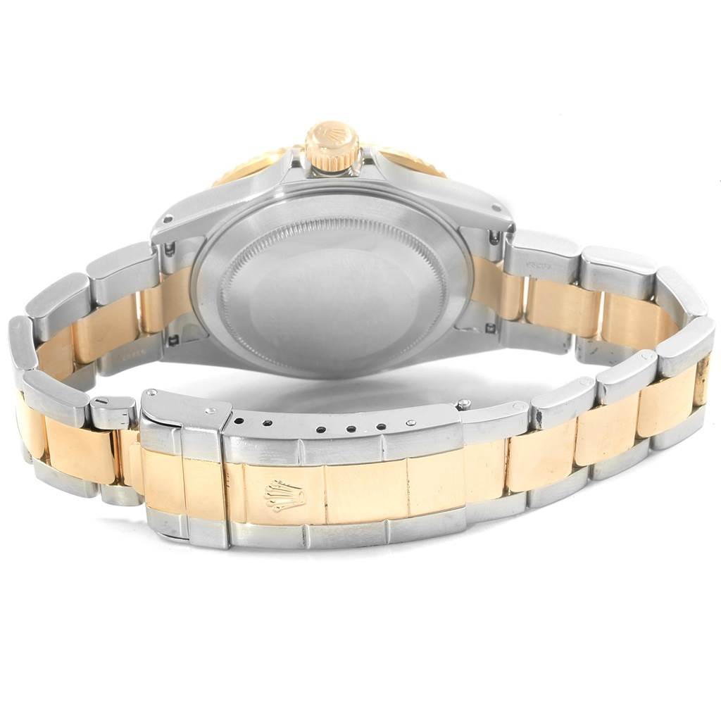 The image shows the backside of the Rolex Submariner 16613 Men
s Steel and Gold (two tone) Blue Dial 16613 Men
s Steel and Gold (two tone) Blue Dial watch, focusing on the case back, crown, and two-tone bracelet.