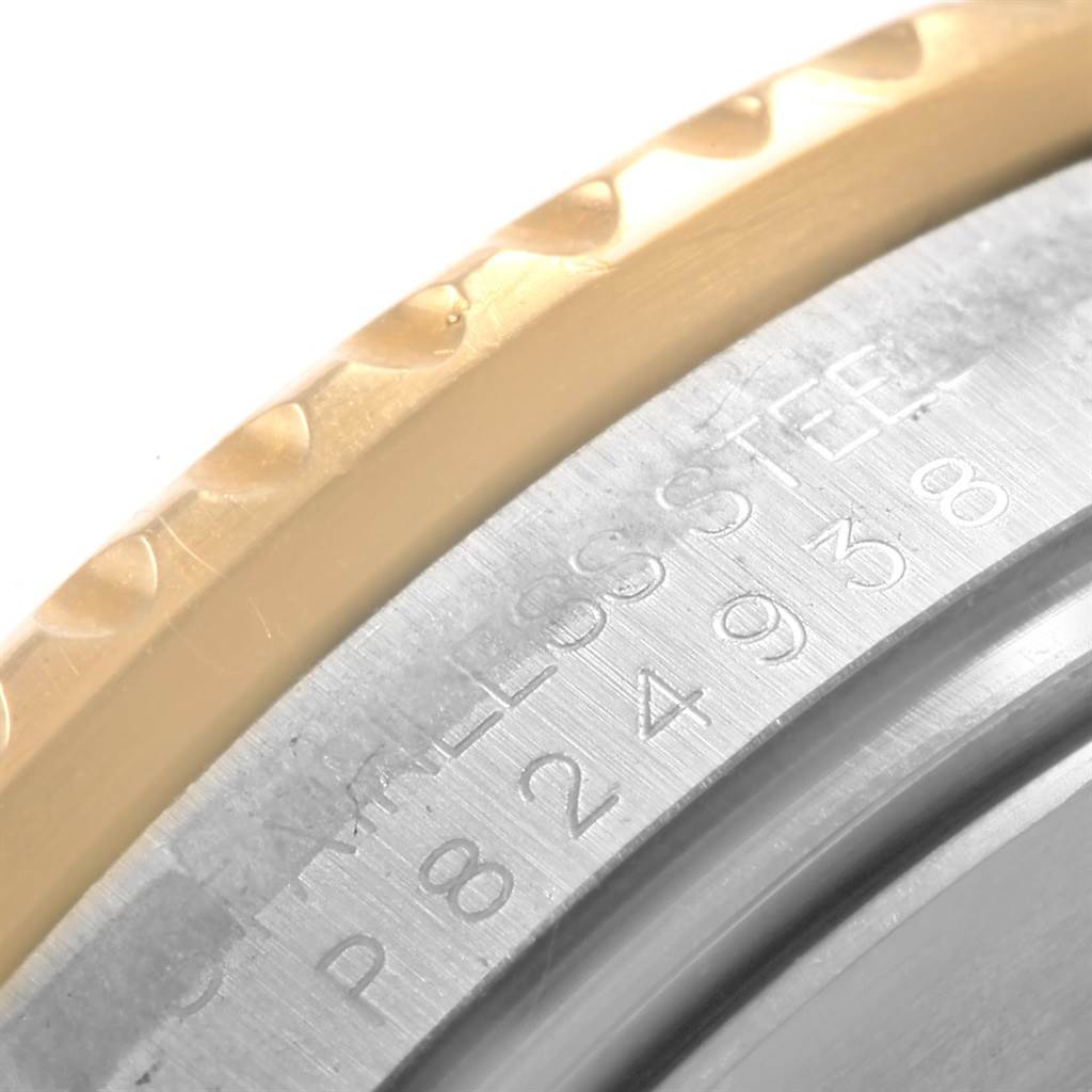 This image shows a close-up of the engraved serial number and part of the bezel on a Rolex Submariner 16613 Men
s Steel and Gold (two tone) Blue Dial 16613 Men
s Steel and Gold (two tone) Blue Dial watch.