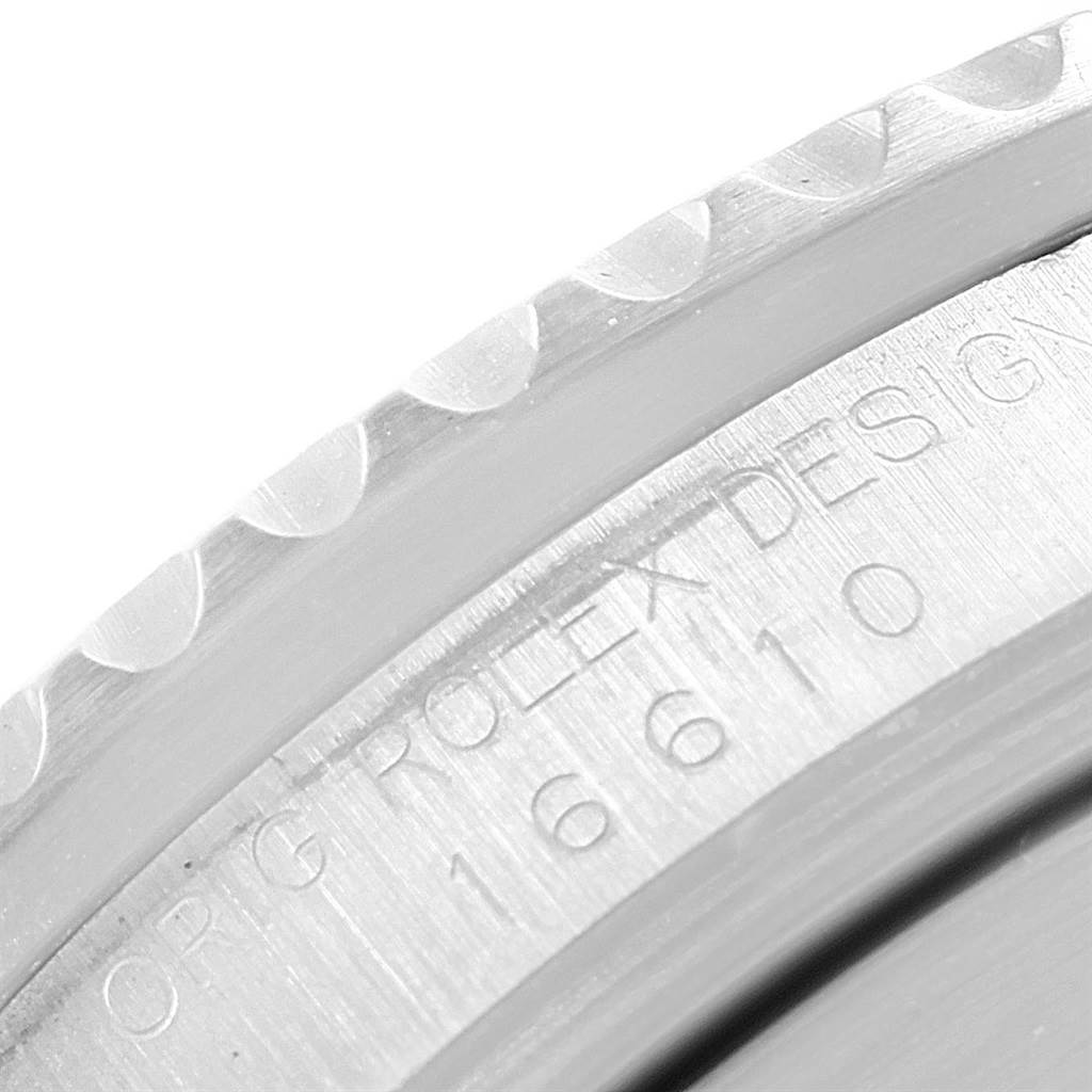 This image shows a close-up angle of the engraved model number and textured bezel of a Rolex Submariner 16610 Men
s Stainless Steel Black Dial 16610 Men
s Stainless Steel Black Dial.