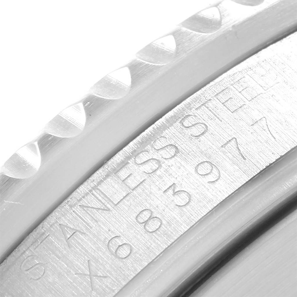 The image shows a close-up of the engraving and knurled edge of the Rolex Submariner 16610 Men
s Stainless Steel Black Dial 16610 Men
s Stainless Steel Black Dial watch
s bezel.