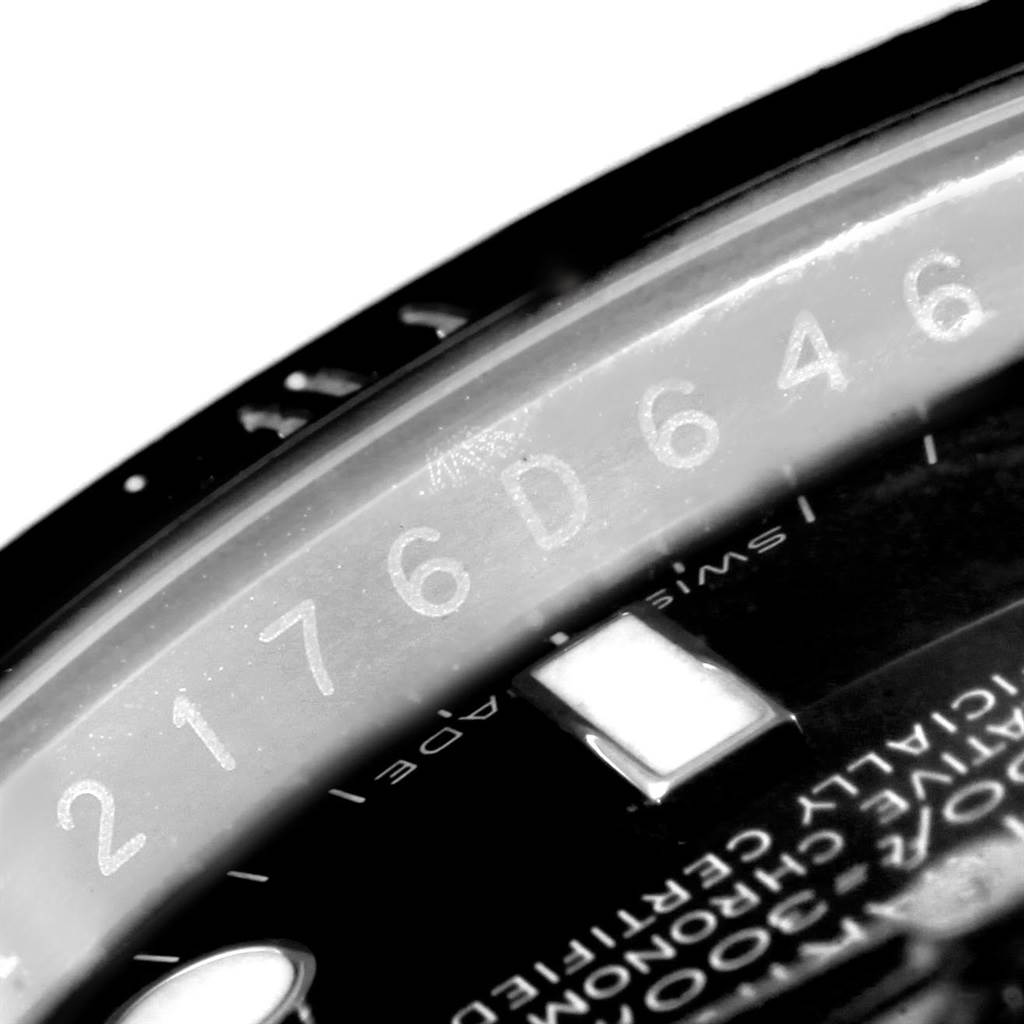 This close-up image of a Rolex Submariner 116610 Men
s Stainless Steel Black Dial 116610 Men
s Stainless Steel Black Dial watch shows part of the dial and the rehaut with the serial number engraved.