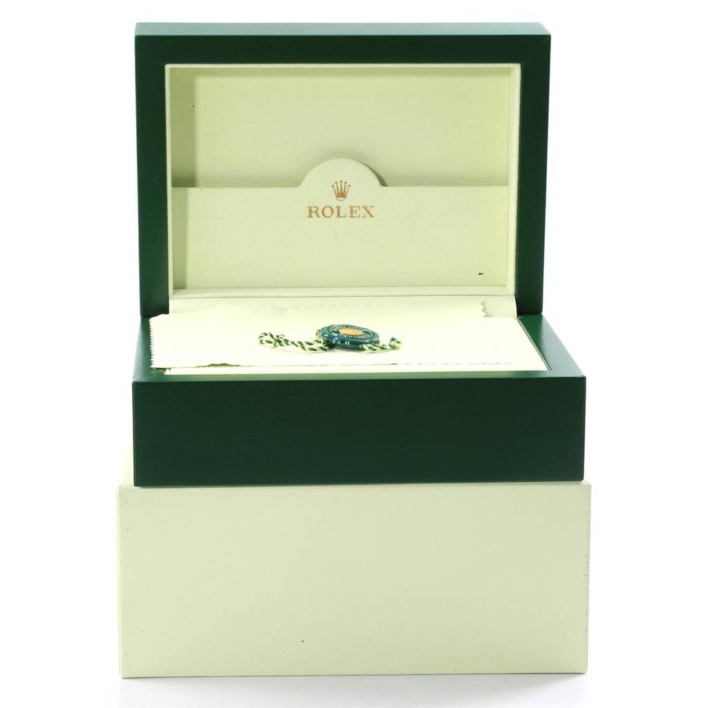 The image shows an open Rolex box for a Submariner model, highlighting the logo and interior compartments.