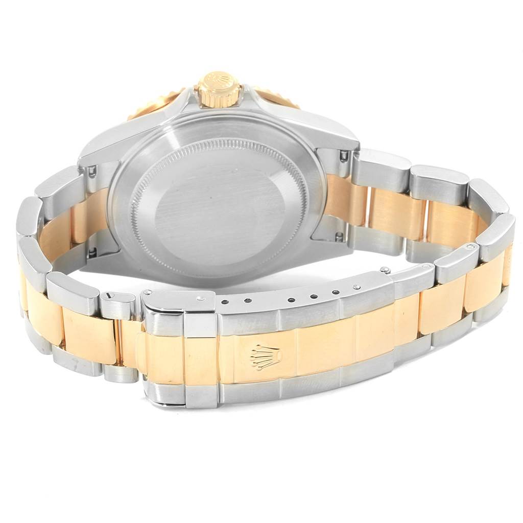 The image shows the back case and bracelet of a Rolex Submariner 16613 Men's Steel and Gold (two tone) Black Dial 16613 Men's Steel and Gold (two tone) Black Dial watch at an angle displaying the crown.