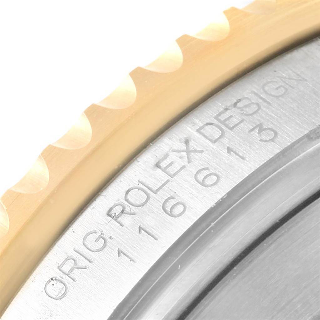 This is a close-up view of the bezel and part of the case back of a Rolex Submariner 116613 Men's Steel and Gold (two tone) Black Dial 116613 Men's Steel and Gold (two tone) Black Dial watch, highlighting the "ORIG. ROLEX DESIGN" engraving.