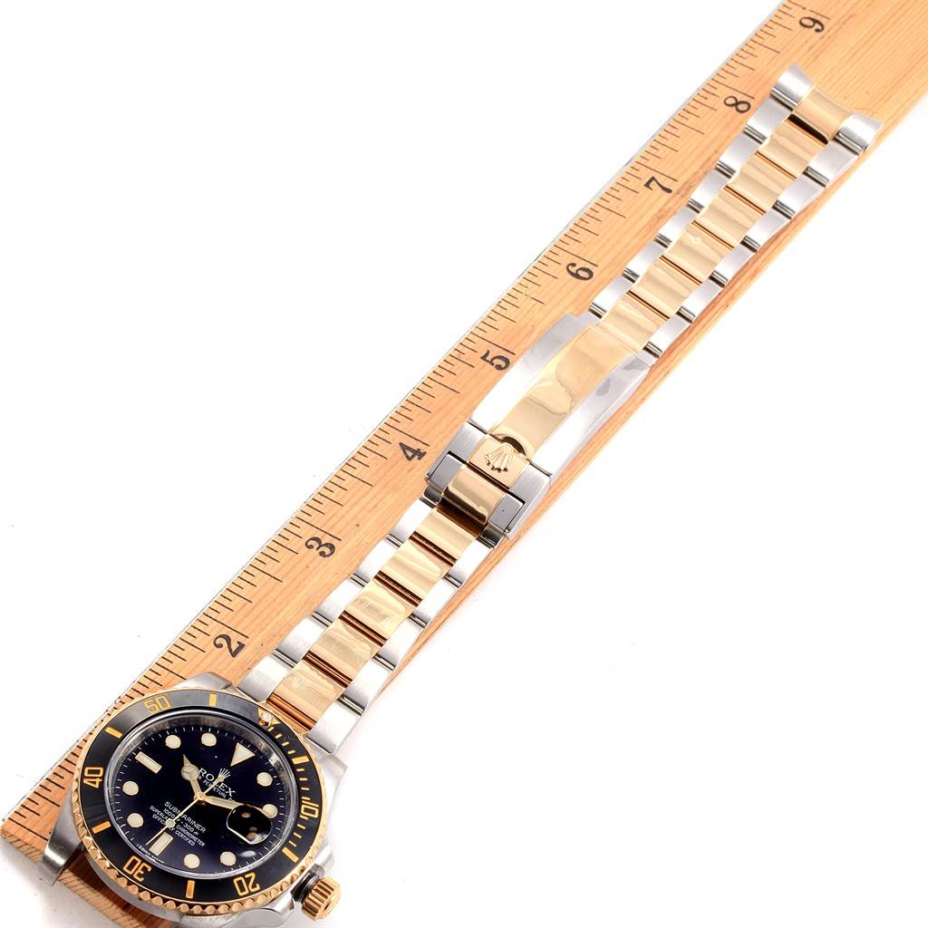 This image shows a top-down view of a Rolex Submariner 116613 Men's Steel and Gold (two tone) Black Dial 116613 Men's Steel and Gold (two tone) Black Dial watch, displaying its band, bezel, and face.