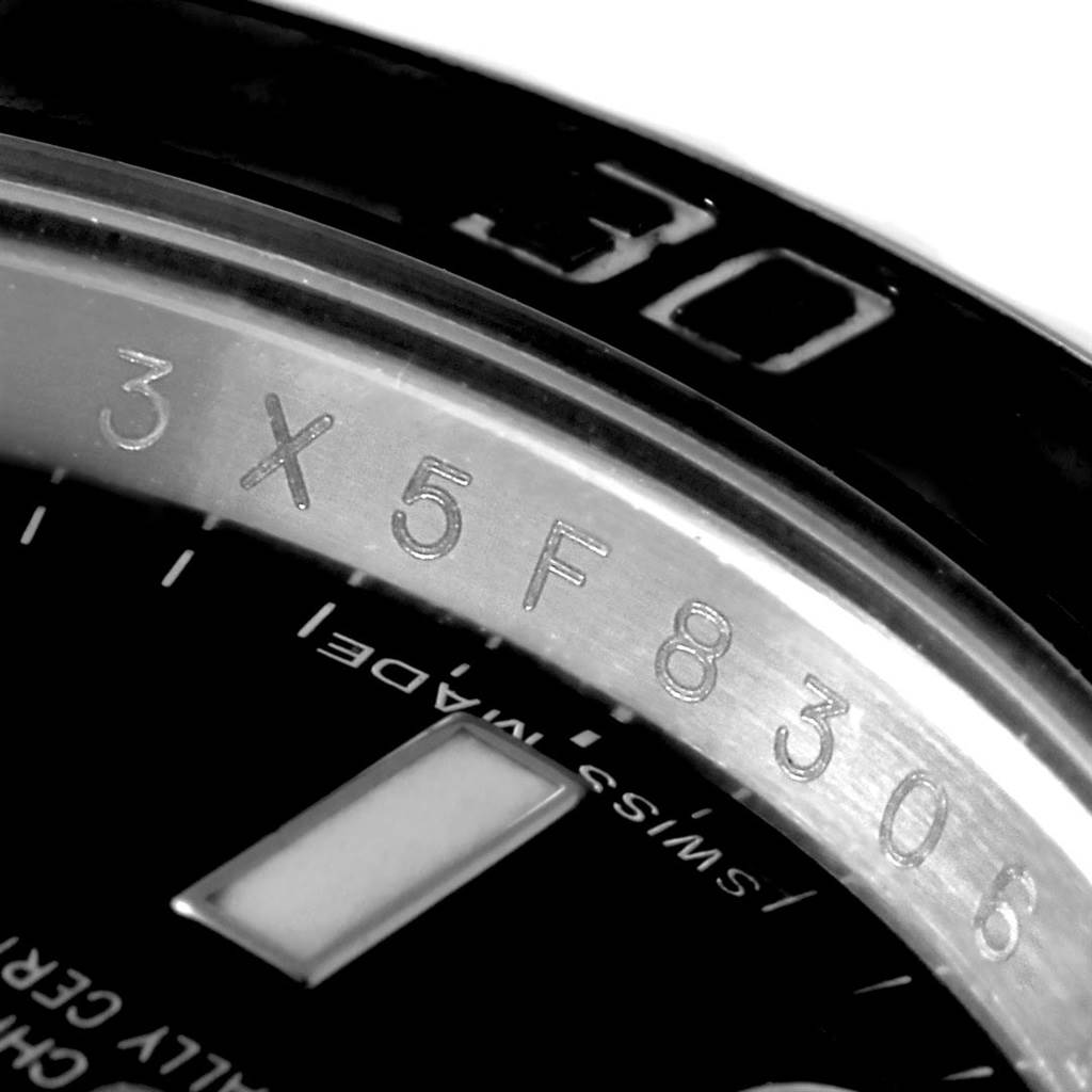 This is a close-up view of a Rolex Submariner 114060 Men
s Stainless Steel Black Dial 114060 Men
s Stainless Steel Black Dial watch showing the rehaut with engraved serial number and part of the dial.