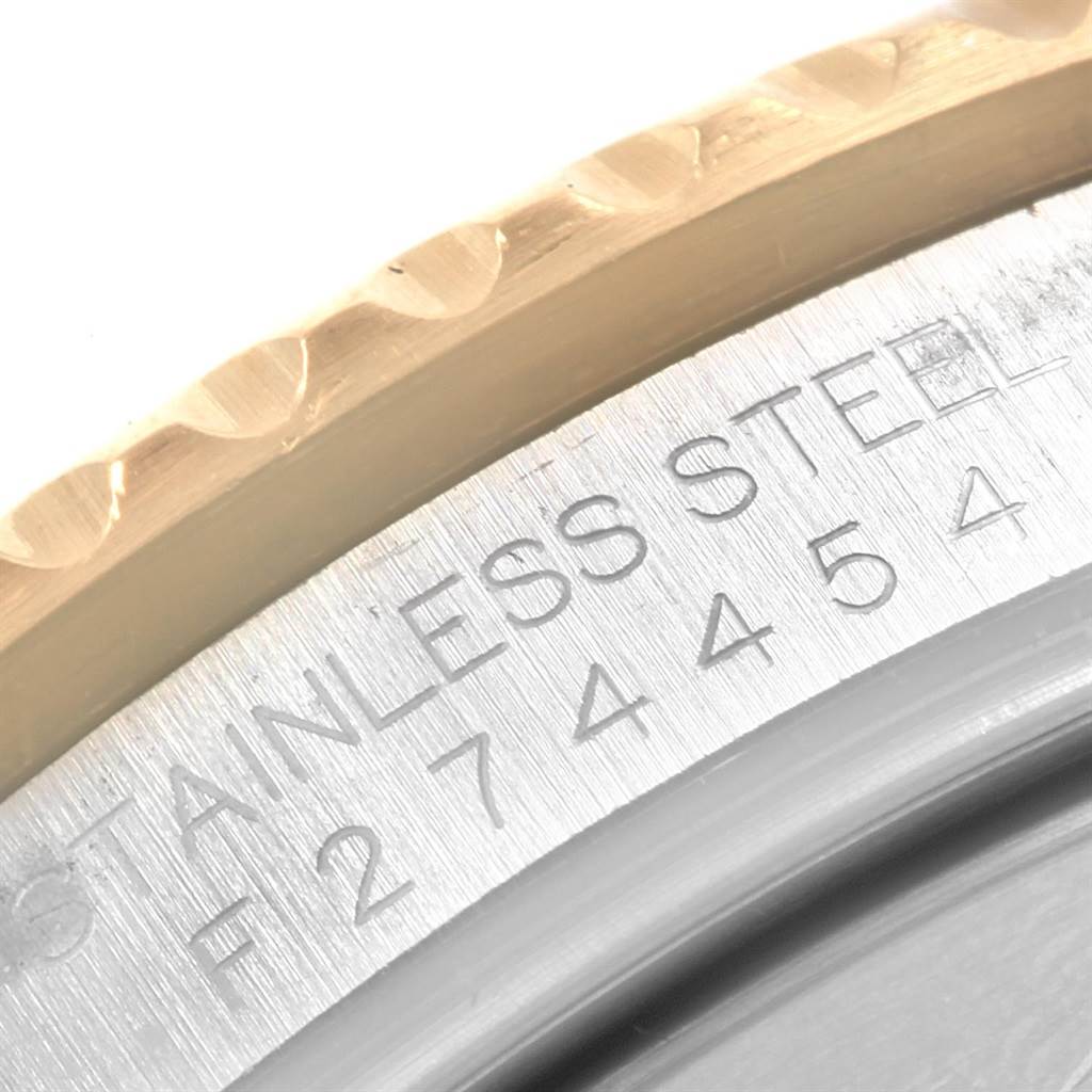 This close-up image shows the engraved serial number and part of the bezel on a Rolex Submariner 16613 Men
s Steel and Gold (two tone) Champagne Dial 16613 Men
s Steel and Gold (two tone) Champagne Dial watch.