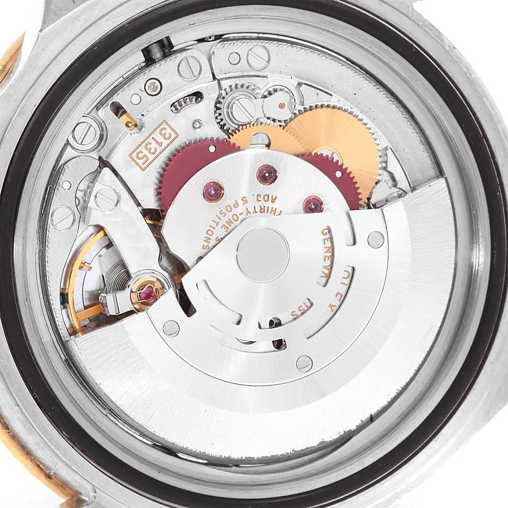 The image shows the internal mechanism and movement of a Rolex Submariner 16613 Men
s Steel and Gold (two tone) Champagne Dial 16613 Men
s Steel and Gold (two tone) Champagne Dial watch from a back angle.