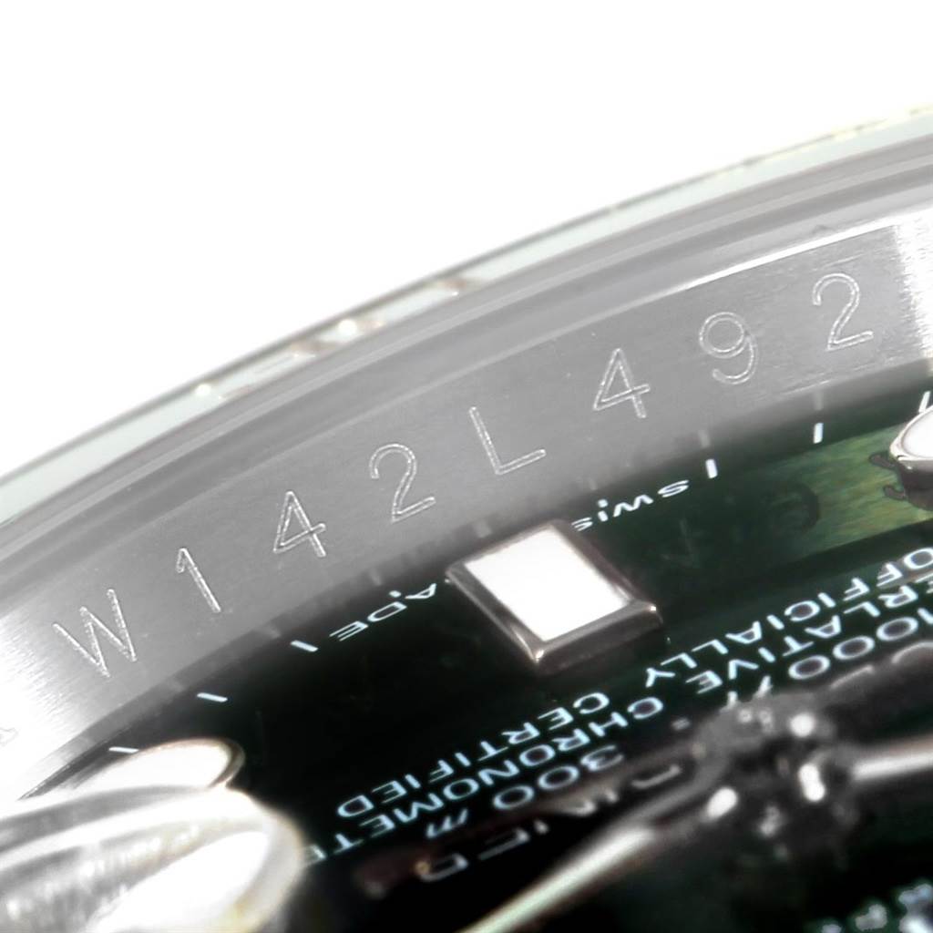 The image shows a close-up angle of the engraved serial number on the inner bezel of a Rolex Submariner 116610LV Men
s Stainless Steel Green Dial 116610LV Men
s Stainless Steel Green Dial watch.