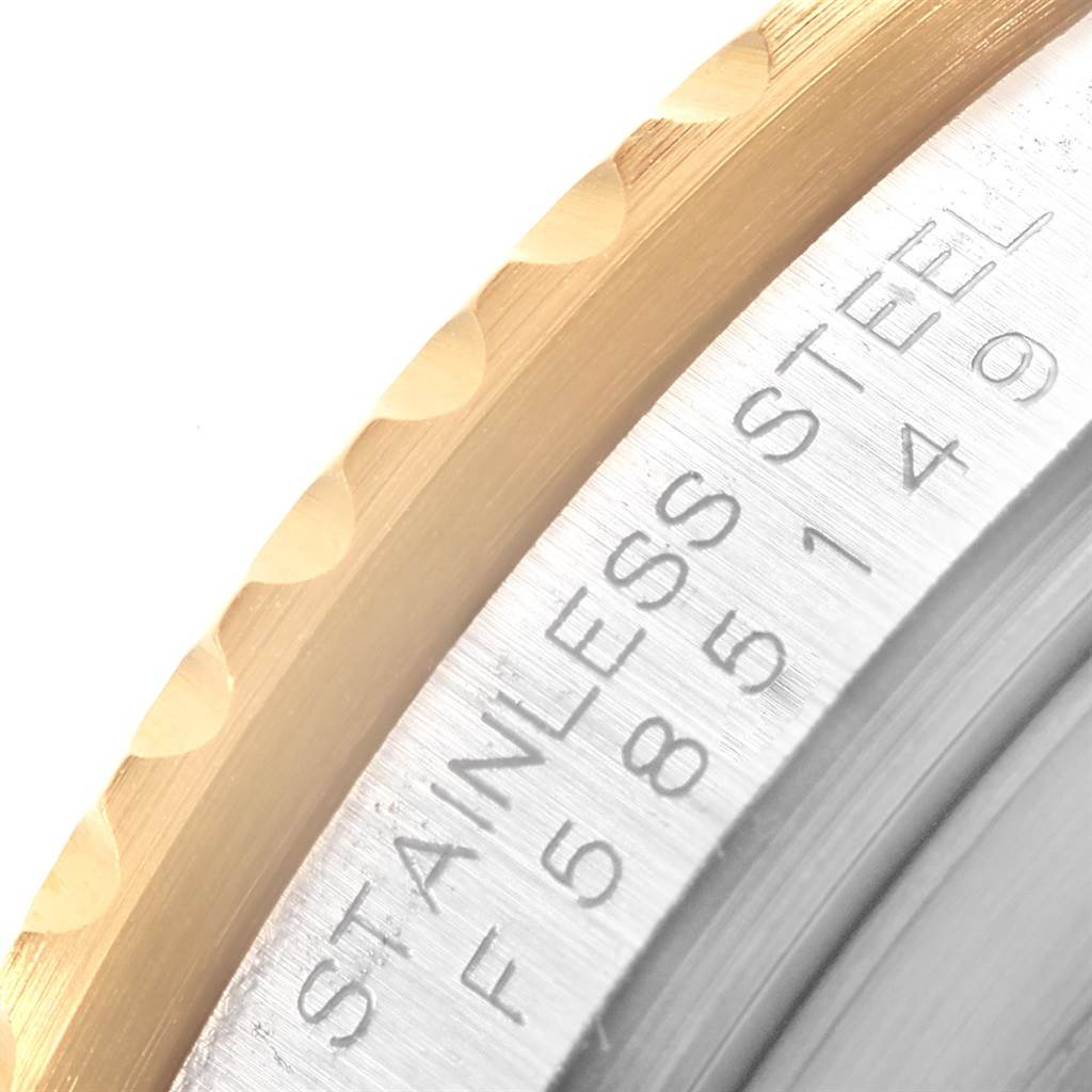 The image shows a close-up of the stainless steel case back and bezel edge of a Rolex Submariner 16613 Men's Steel and Gold (two tone) Black Dial 16613 Men's Steel and Gold (two tone) Black Dial watch.