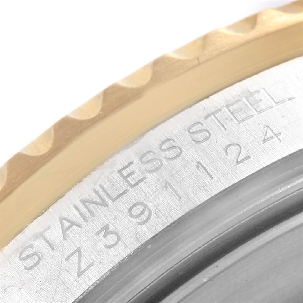 This image shows a close-up of the stainless steel outer edge and serial number of a Rolex Submariner 16613 Men's Steel and Gold (two tone) Black Dial 16613 Men's Steel and Gold (two tone) Black Dial watch.