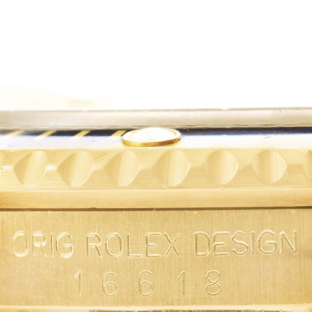 The image shows a close-up of the side of a Rolex Submariner 16618 Men's Yellow Gold Champagne Dial 16618 Men's Yellow Gold Champagne Dial watch, highlighting the engraved text and bezel details.