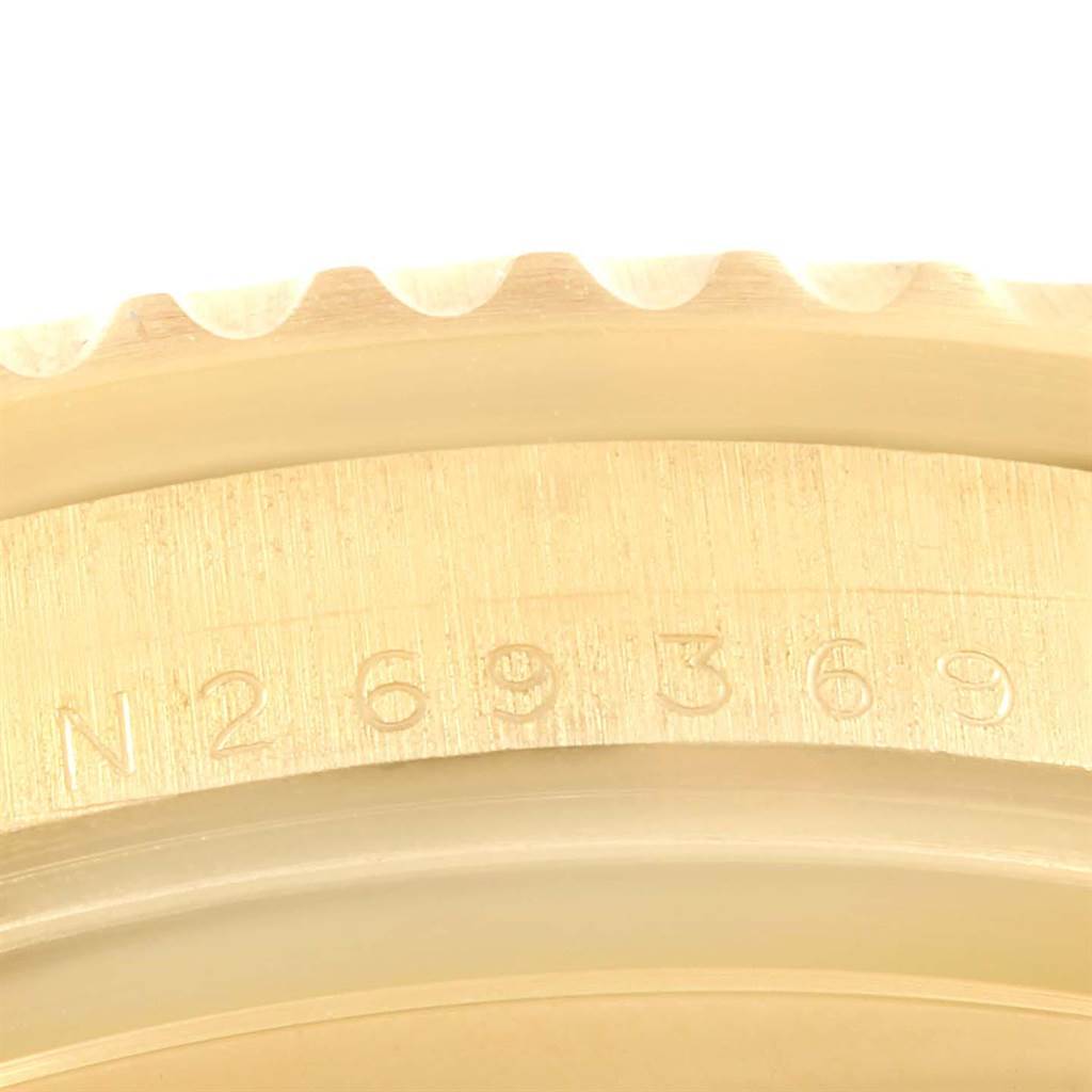 This close-up view shows the edge of the bezel and part of the case of a Rolex Submariner 16618 Men's Yellow Gold Champagne Dial 16618 Men's Yellow Gold Champagne Dial.