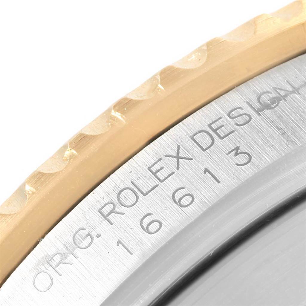 The image shows a close-up of the bezel and engraved edge of the Rolex Submariner 16613 Men's Steel and Gold (two tone) Blue Dial 16613 Men's Steel and Gold (two tone) Blue Dial model.