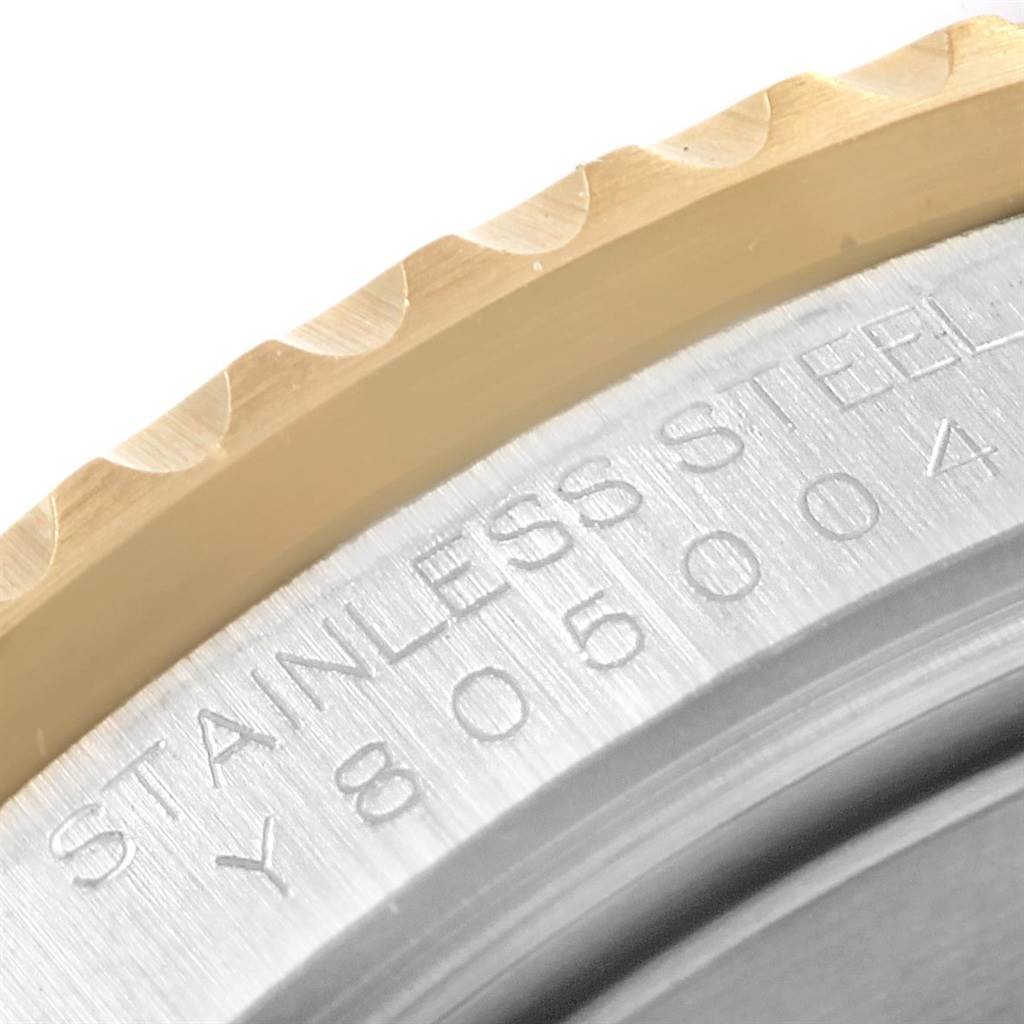 The image shows a close-up of the bezel and part of the stainless steel case back of a Rolex Submariner 16613 Men's Steel and Gold (two tone) Blue Dial 16613 Men's Steel and Gold (two tone) Blue Dial watch.