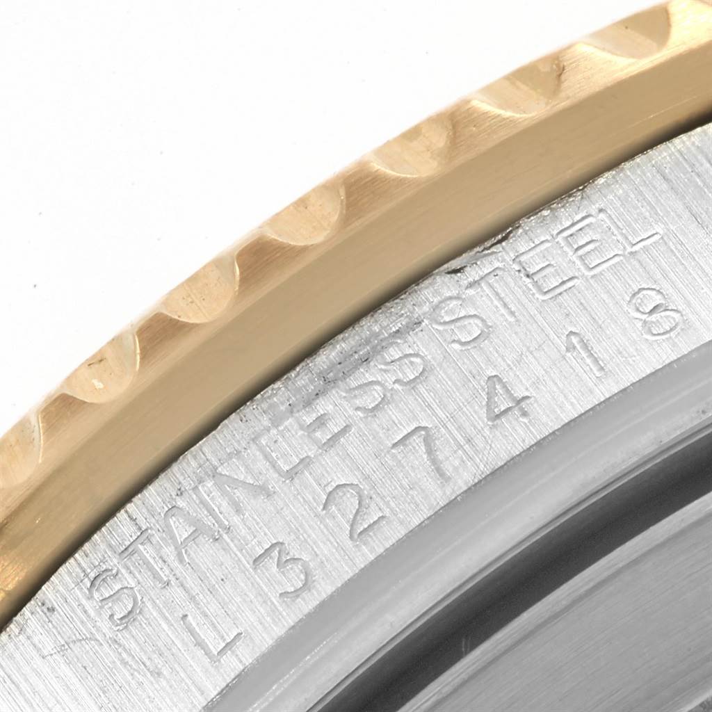 The image shows a close-up of the side engraving and bezel on a Rolex Submariner 16613 Men's Steel and Gold (two tone) Blue Dial 16613 Men's Steel and Gold (two tone) Blue Dial watch, highlighting "STAINLESS STEEL" and a serial number.