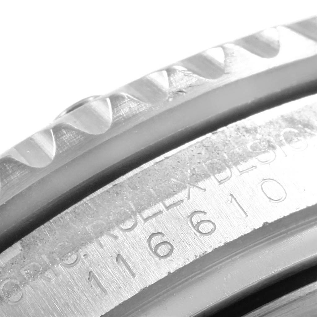 This close-up image shows the engraved model number and the knurled edge of the bezel on a Rolex Submariner 116610LV Men's Stainless Steel Green Dial 116610LV Men's Stainless Steel Green Dial watch.