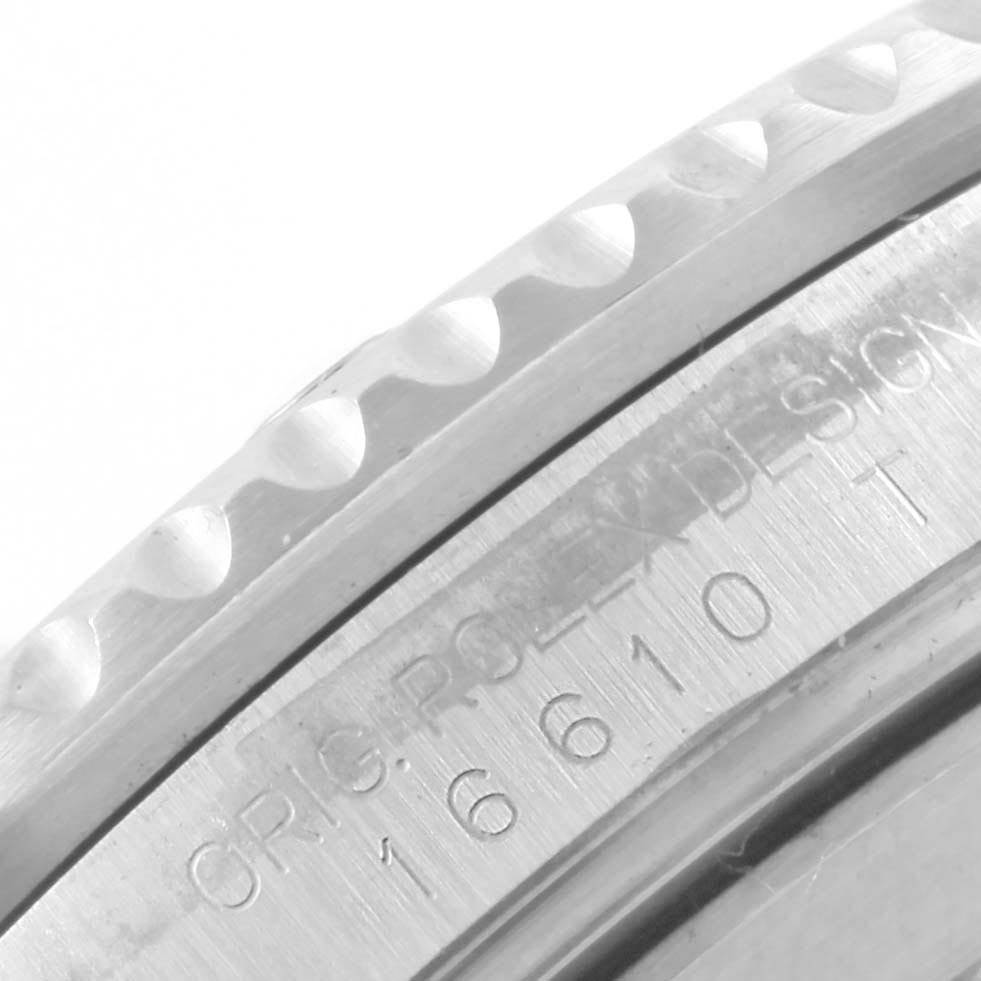 The image shows a close-up of the bezel and serial engraving on a Rolex Submariner 16610 Men
s Stainless Steel Black Dial 16610 Men
s Stainless Steel Black Dial watch.