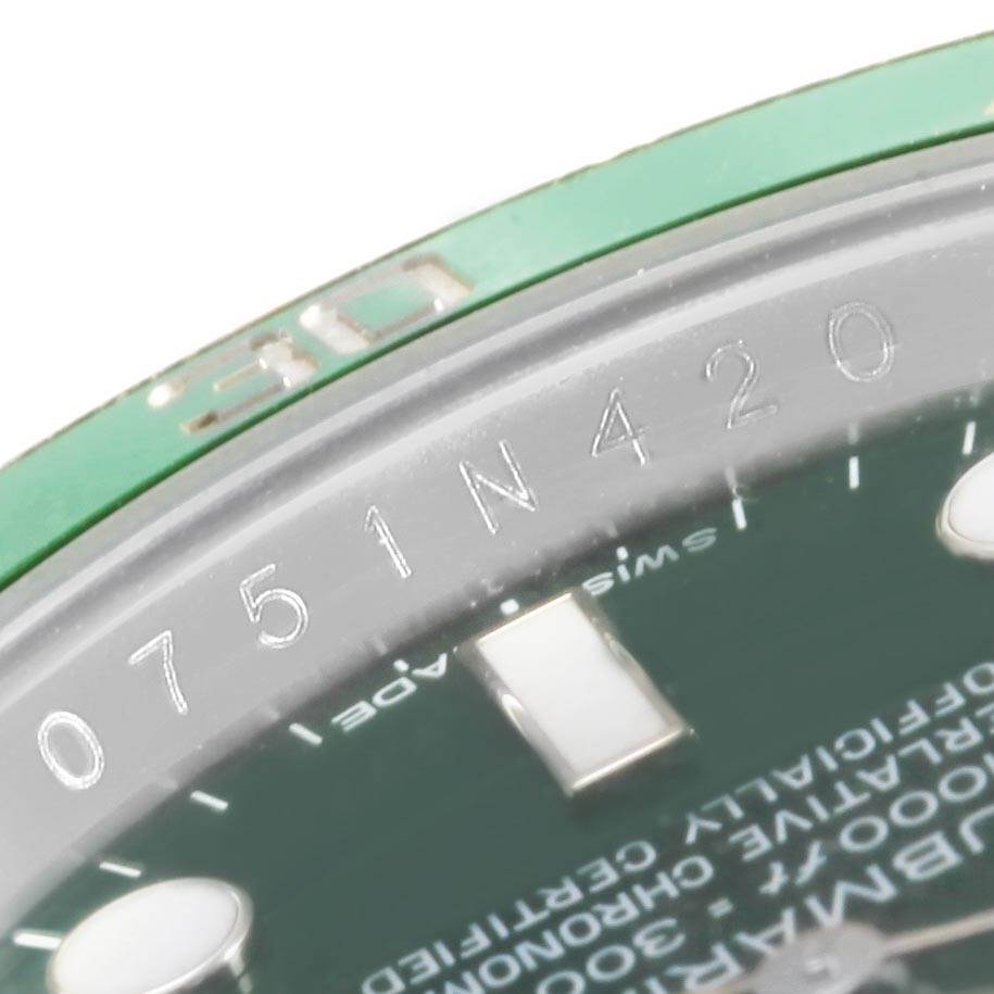 This image shows the engraving and part of the bezel and dial of a Rolex Submariner 116610LV Men's Stainless Steel Green Dial 116610LV Men's Stainless Steel Green Dial watch.