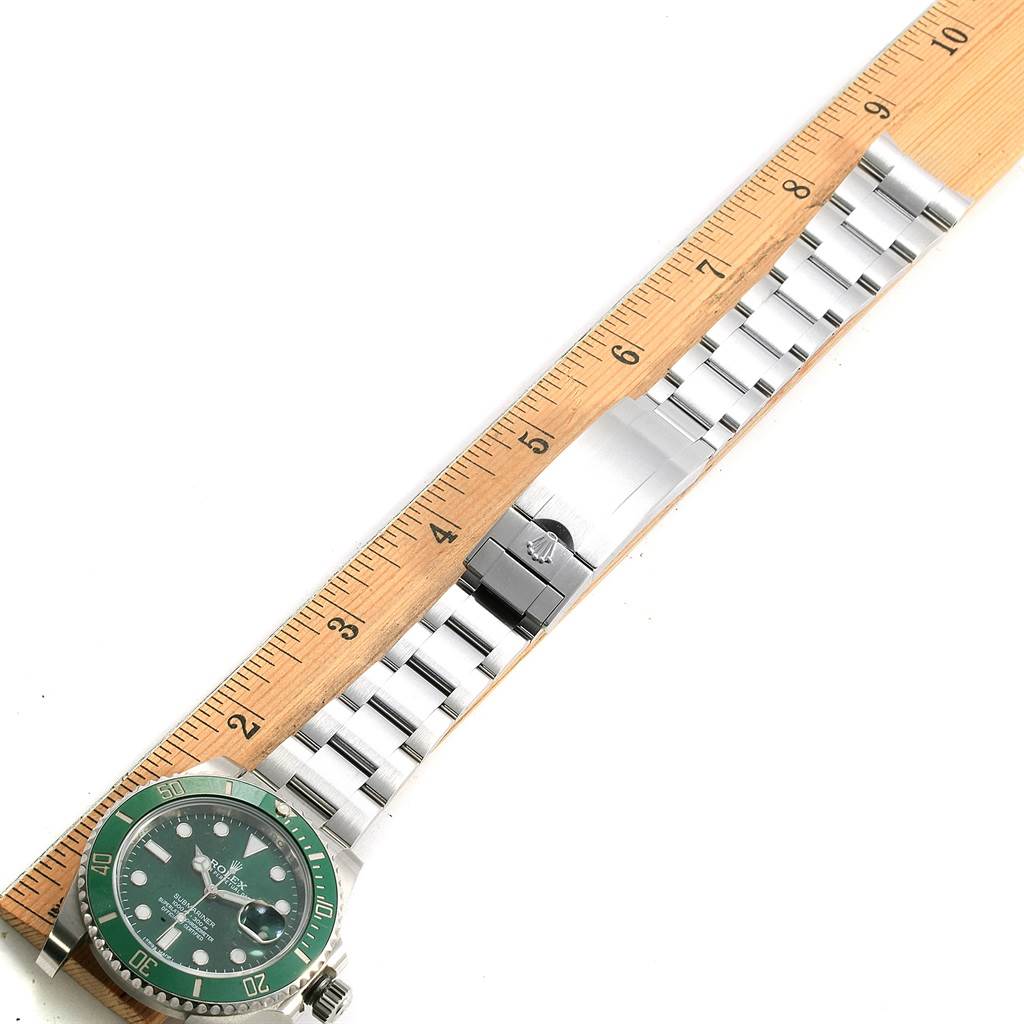 The image shows a top-down view of a Rolex Submariner 116610LV Men's Stainless Steel Green Dial 116610LV Men's Stainless Steel Green Dial watch with its face and full bracelet measured against a ruler.