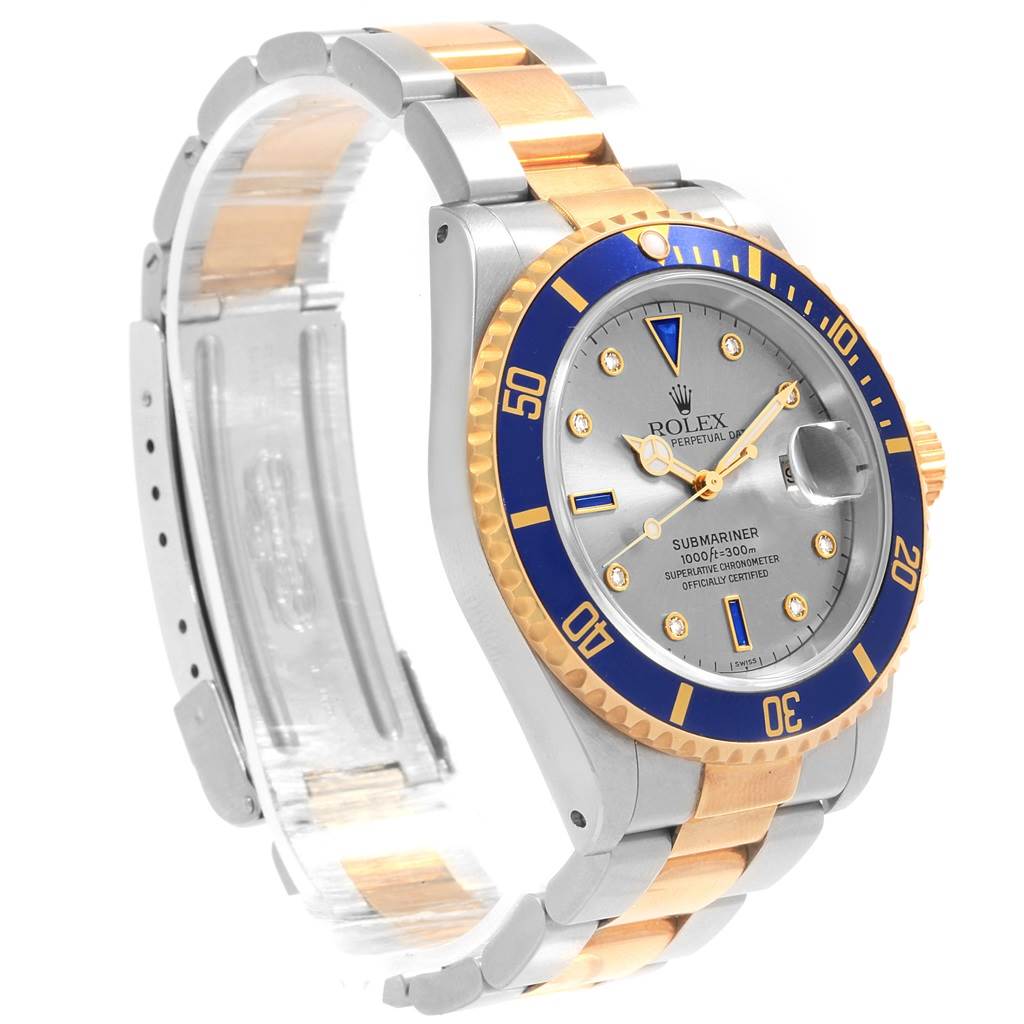 The Rolex Submariner 16613 Men's Steel and Gold (two tone) Grey Dial 16613 Men's Steel and Gold (two tone) Grey Dial watch is shown at an angled view, highlighting the dial, bezel, crown, and bracelet.