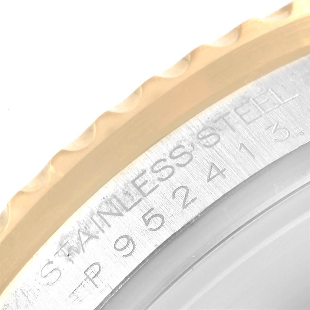 The image shows a close-up of the engraved text on the caseback edge of a Rolex Submariner 16613 Men's Steel and Gold (two tone) Champagne Dial 16613 Men's Steel and Gold (two tone) Champagne Dial watch.