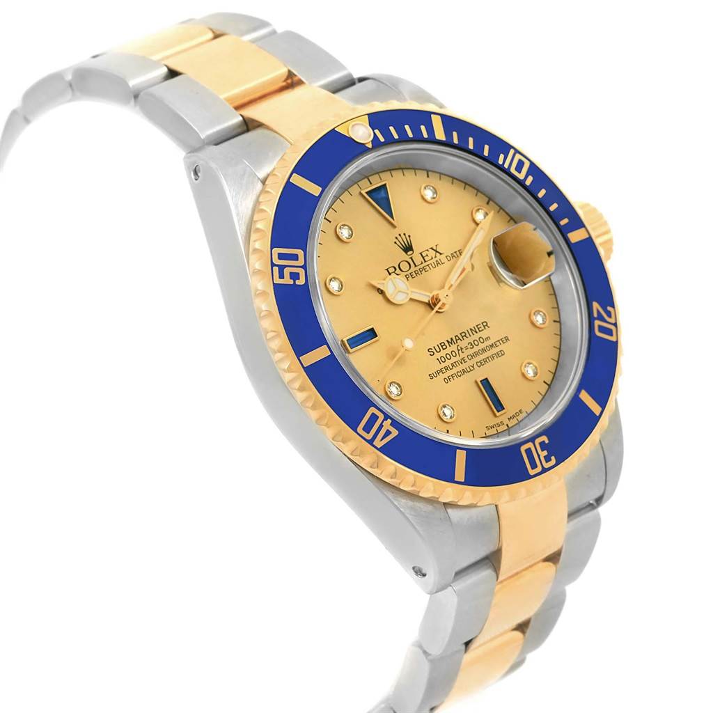 The image shows a three-quarter angle view of the Rolex Submariner 16613 Men's Steel and Gold (two tone) Champagne Dial 16613 Men's Steel and Gold (two tone) Champagne Dial, highlighting its gold and silver bracelet, blue bezel, and gold dial.