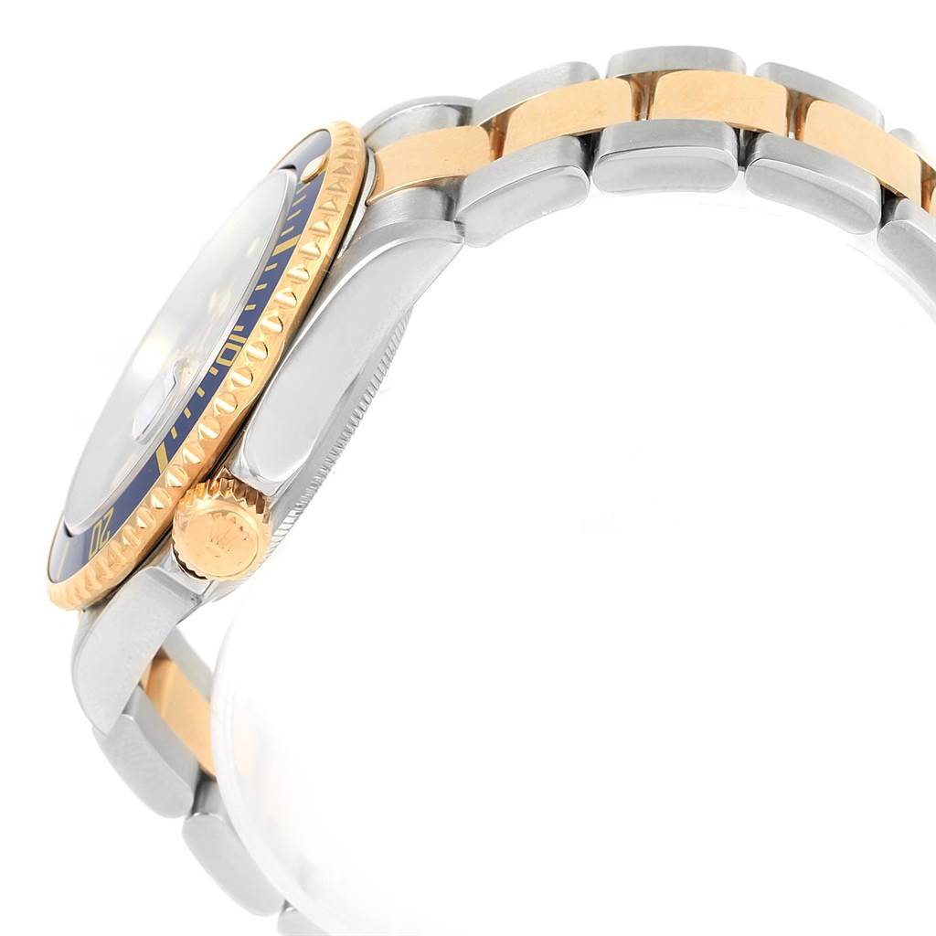 The image shows a side view of a Rolex Submariner 16613 Men's Steel and Gold (two tone) Blue Dial 16613 Men's Steel and Gold (two tone) Blue Dial watch focusing on the bezel, crown, and part of the bracelet.