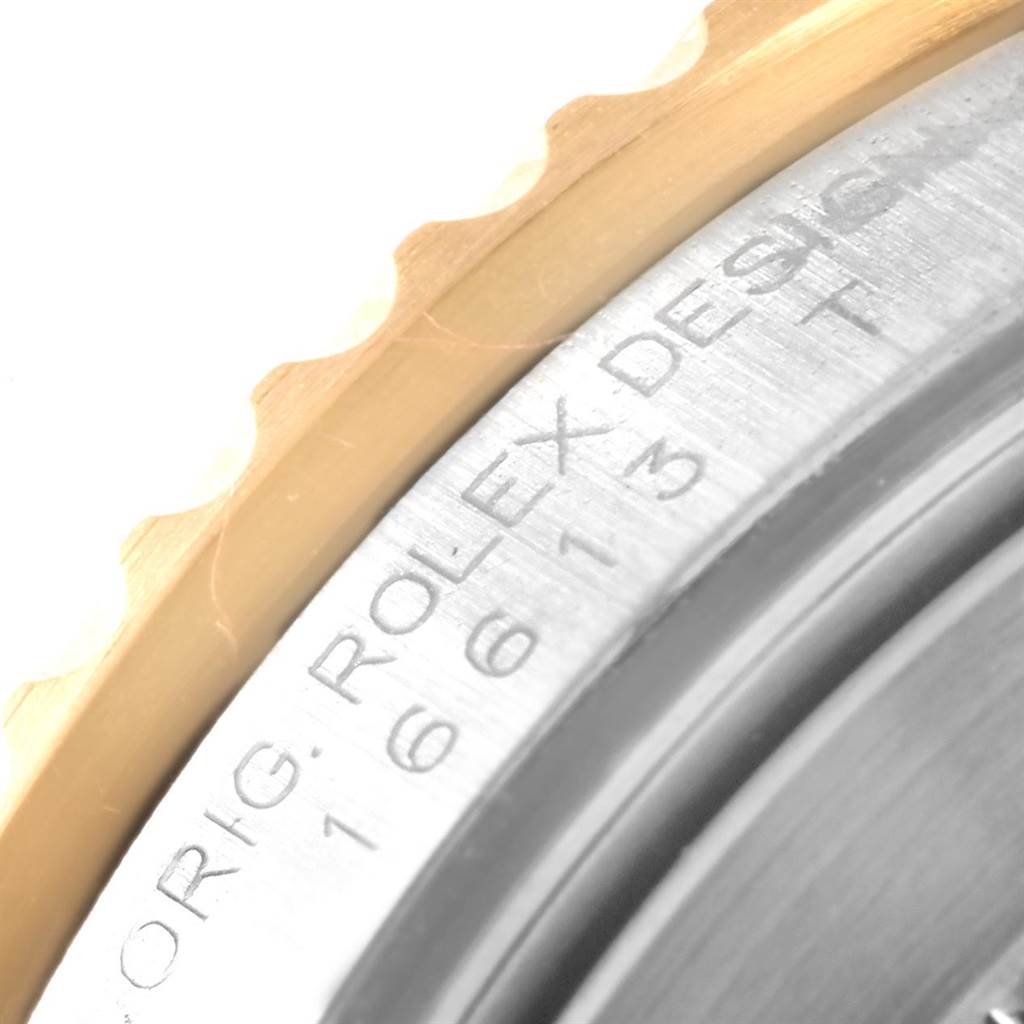 The image shows a close-up of the edge of the bezel and the engraved serial number on the case of the Rolex Submariner 16613 Men's Steel and Gold (two tone) Blue Dial 16613 Men's Steel and Gold (two tone) Blue Dial watch.