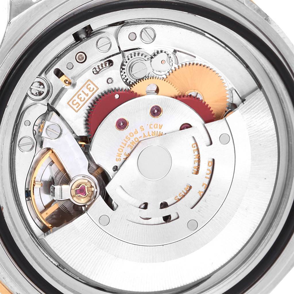 The image shows a close-up of the movement inside a Rolex Submariner 16613 Men's Steel and Gold (two tone) Blue Dial 16613 Men's Steel and Gold (two tone) Blue Dial watch, highlighting gears and other internal components.