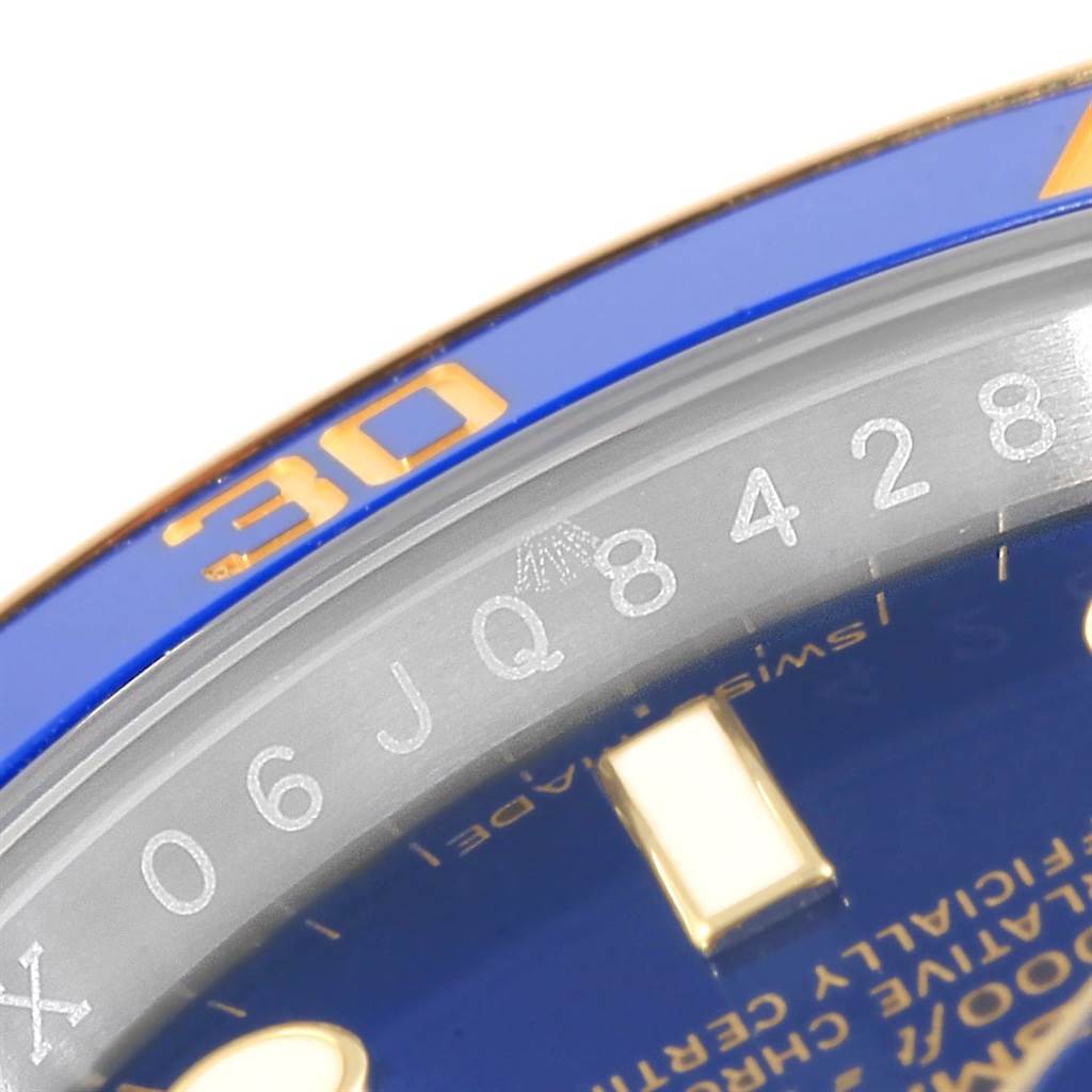 The image shows a close-up angle of the bezel and part of the dial on a Rolex Submariner 116613 Men's Steel and Gold (two tone) Blue Dial 116613 Men's Steel and Gold (two tone) Blue Dial watch.