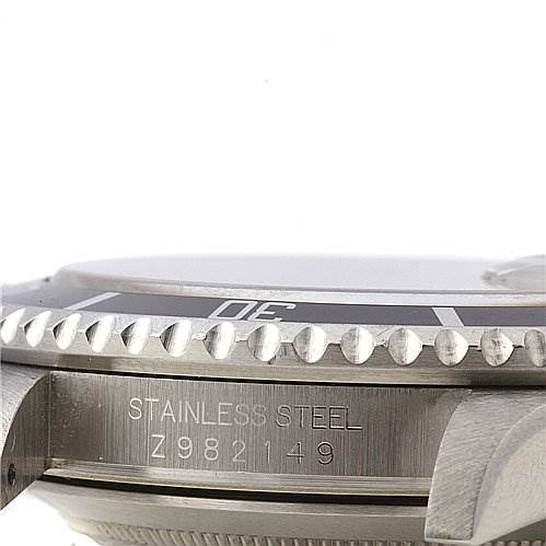 The image shows a close-up side view of the Rolex Submariner 16610 Men's Stainless Steel Black Dial 16610 Men's Stainless Steel Black Dial, focusing on the case, bezel, and engraved serial number.