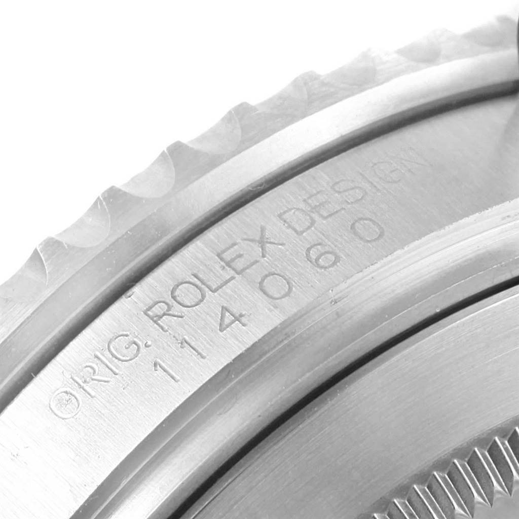 This image shows a close-up of the case back and edge of the Rolex Submariner 114060 Men's Stainless Steel Black Dial 114060 Men's Stainless Steel Black Dial, revealing the manufacturer's engraving.