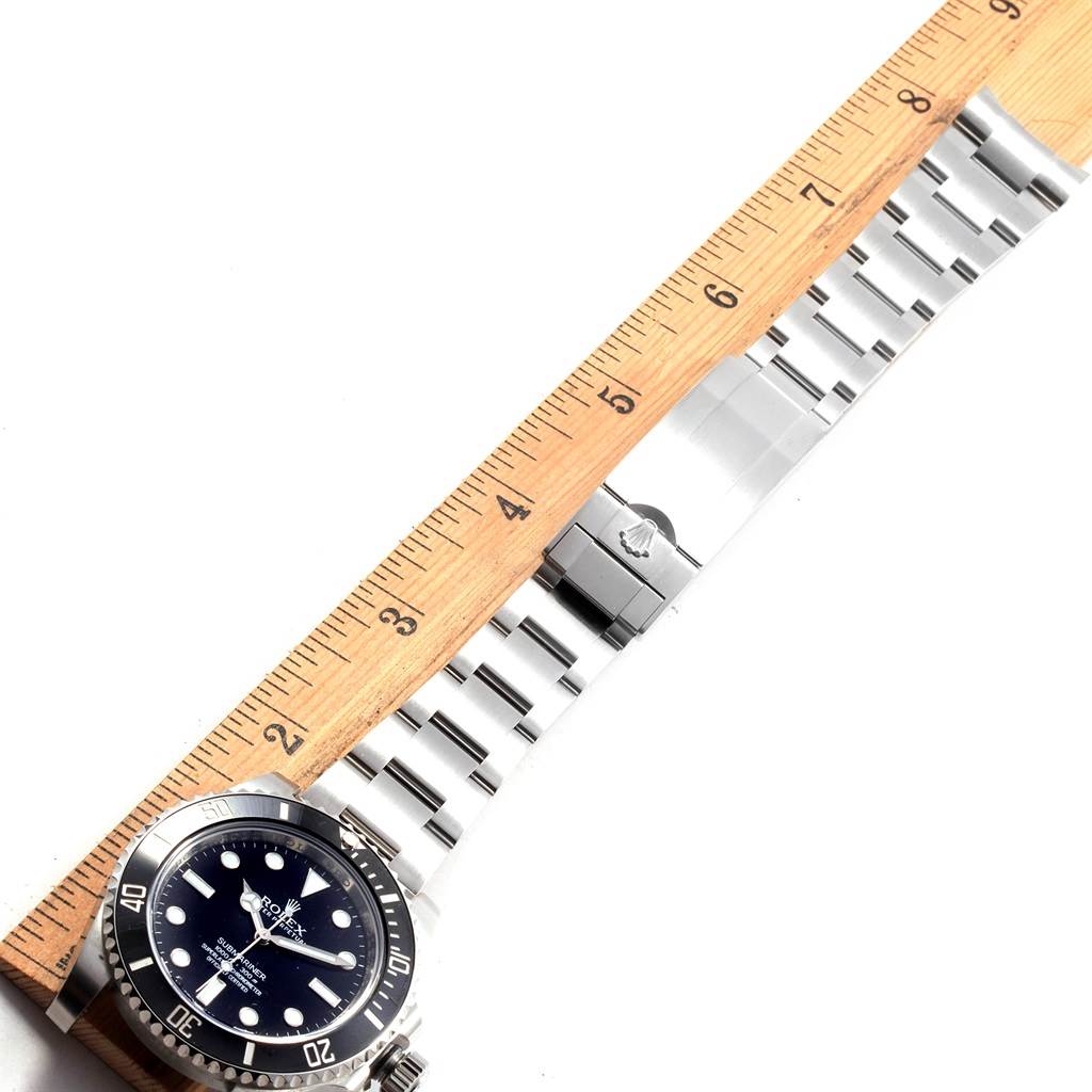 The image shows a Rolex Submariner 114060 Men's Stainless Steel Black Dial 114060 Men's Stainless Steel Black Dial watch laid flat with a ruler measuring its stainless steel bracelet and clasp.