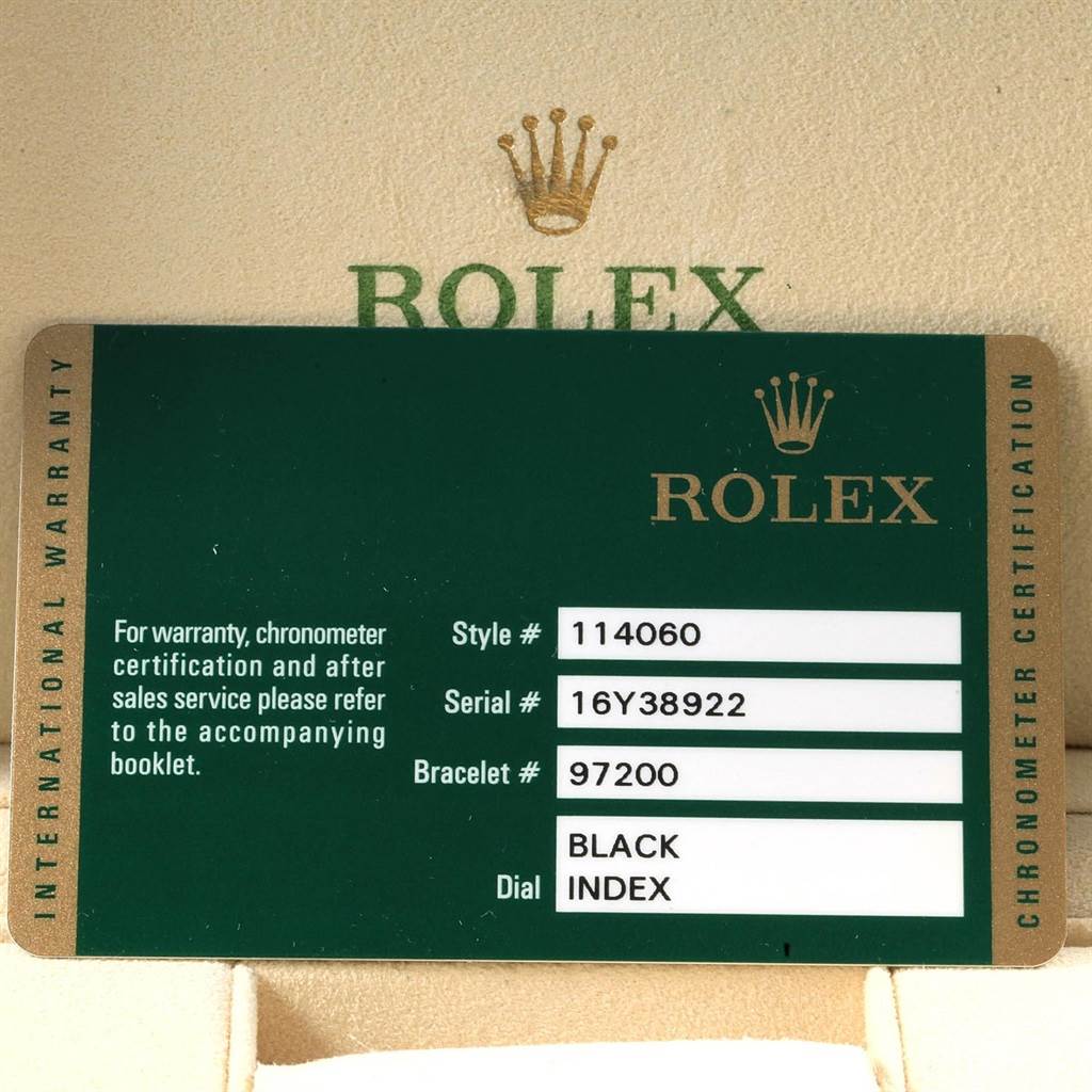 This image shows a close-up of a warranty card for a Rolex Submariner 114060 Men's Stainless Steel Black Dial 114060 Men's Stainless Steel Black Dial model.