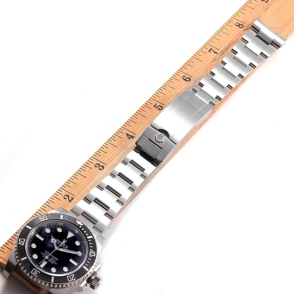 The image shows a Rolex Submariner 114060 Men's Stainless Steel Black Dial 114060 Men's Stainless Steel Black Dial watch laid flat with the bracelet alongside a ruler for measurement.