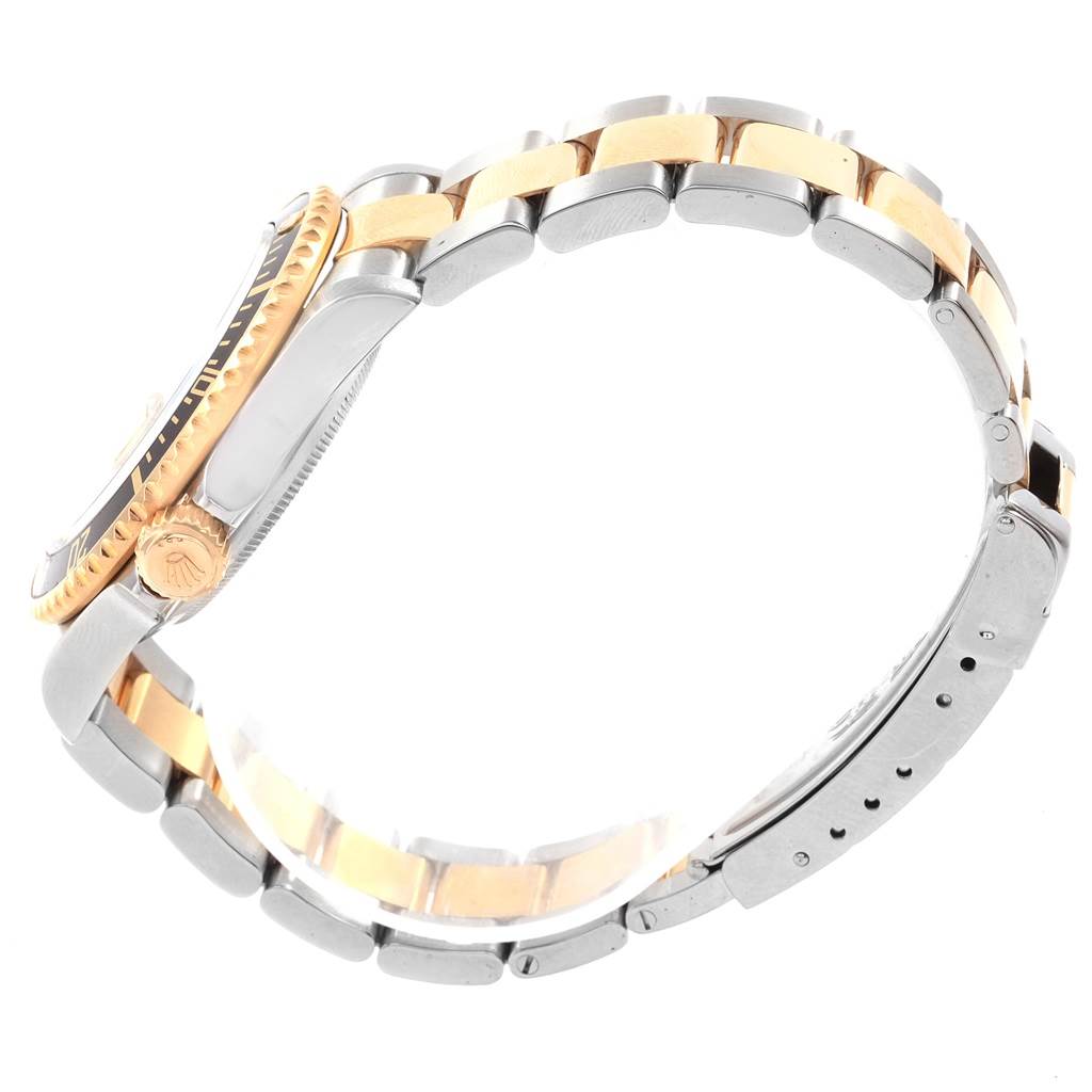 The side view shows the case, crown, bezel, and the two-tone bracelet of the Rolex Submariner 16613 Men's Steel and Gold (two tone) Champagne Dial 16613 Men's Steel and Gold (two tone) Champagne Dial watch.