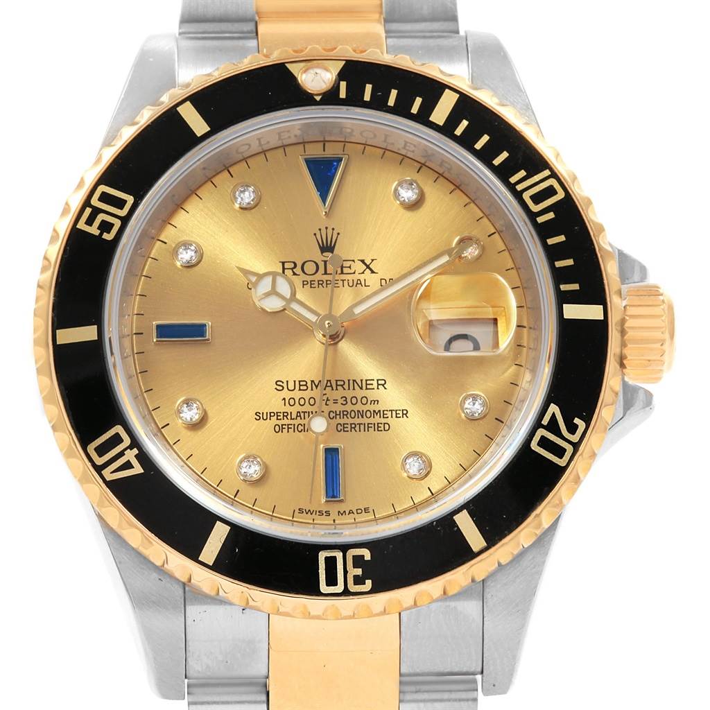 The image shows a front angle of the Rolex Submariner 16613 Men's Steel and Gold (two tone) Champagne Dial 16613 Men's Steel and Gold (two tone) Champagne Dial watch, displaying its gold dial, black bezel, and two-tone metal bracelet.