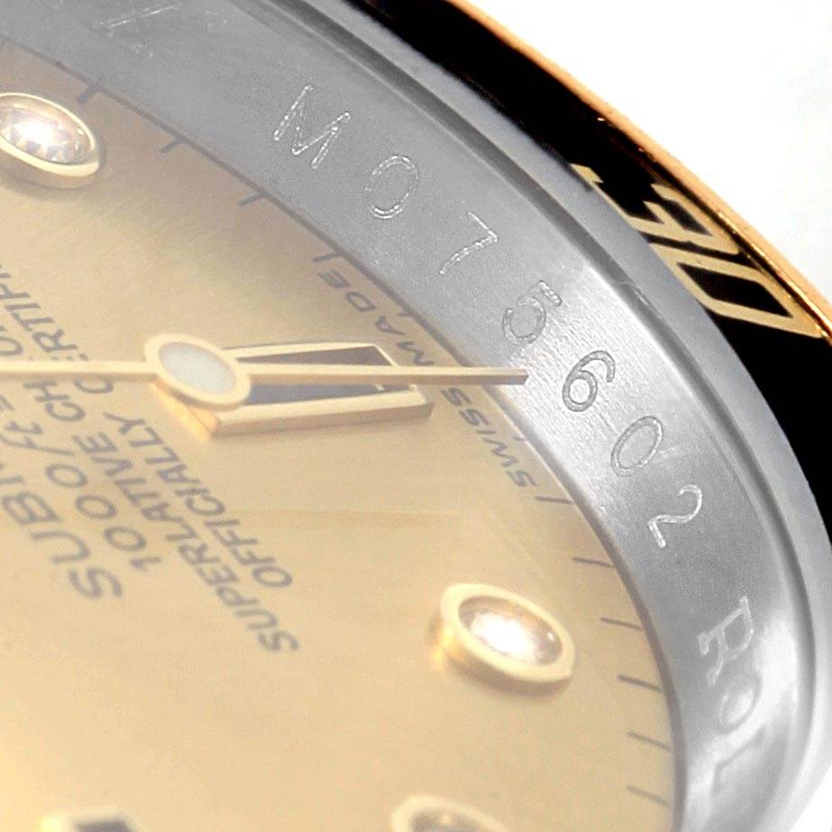 The image shows a close-up angle of the dial and engraved serial number on the Rolex Submariner 16613 Men's Steel and Gold (two tone) Champagne Dial 16613 Men's Steel and Gold (two tone) Champagne Dial watch.