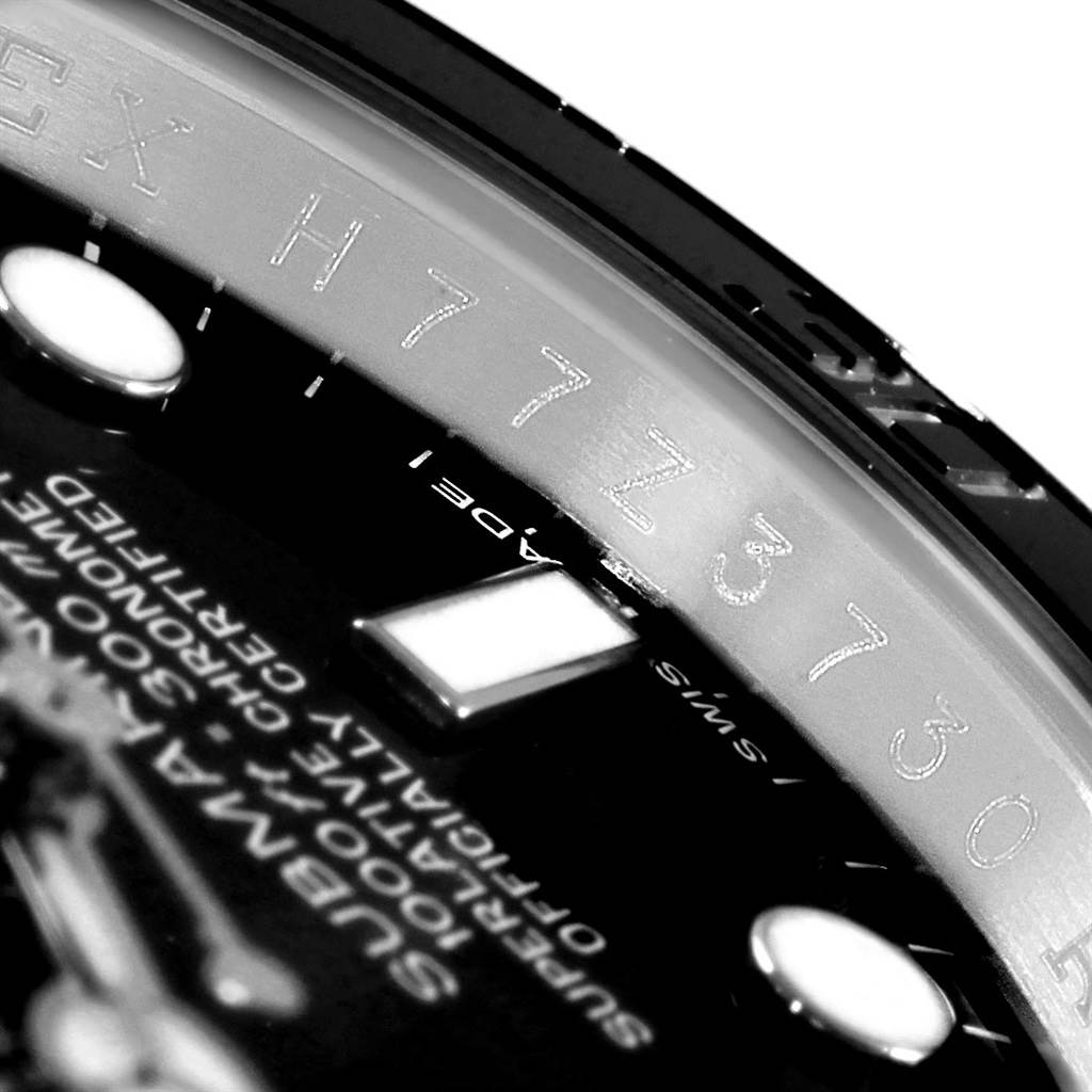 This image shows a close-up of the serial number and part of the dial on a Rolex Submariner 116610 Men's Stainless Steel Black Dial 116610 Men's Stainless Steel Black Dial watch.