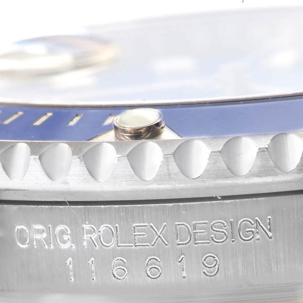 The close-up image shows the bezel, a lume pip, and part of the case with the engraving of the model number "116619" of the Rolex Submariner 116619 Men's White Gold Blue Dial 116619 Men's White Gold Blue Dial.