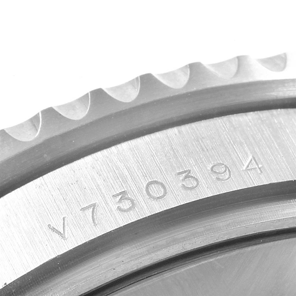 This close-up image shows the engraved serial number on the bezel of a Rolex Submariner 116619 Men's White Gold Blue Dial 116619 Men's White Gold Blue Dial watch.